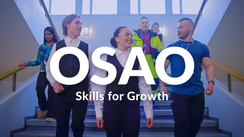 A group of six people descending stairs in a building, with the text 'OSAO Skills for Growth' overlayed. Two people are wearing formal attire, one is in casual clothes, and two are in work uniforms. They appear to be smiling and engaged in conversation.
