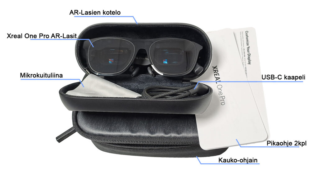 Kuva esittää Xreal One Pro AR-laseja avatussa kotelossa. Kotelossa on myös mikrokuituliina, USB-C kaapeli, pikaohjeet ja kauko-ohjain.