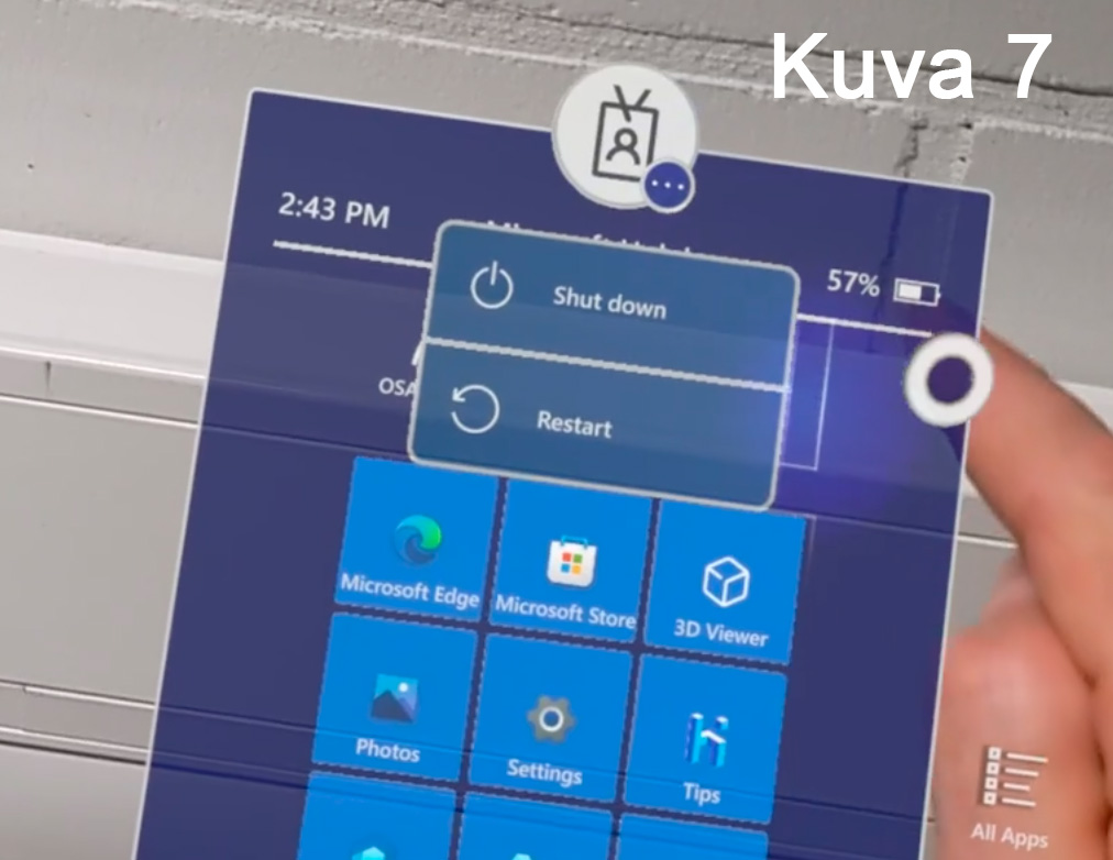 Käsi koskettaa digitaalista käyttöliittymää, jossa näkyvät Windowsin valikot, kuten 'Shut down' ja 'Restart'. Näytöllä on myös sovelluksia kuten Microsoft Edge ja Microsoft Store. Oikeassa yläkulmassa on akun varaustaso ja kellonaika 2:43 PM. Kuvassa lukee 'Kuva 7'.